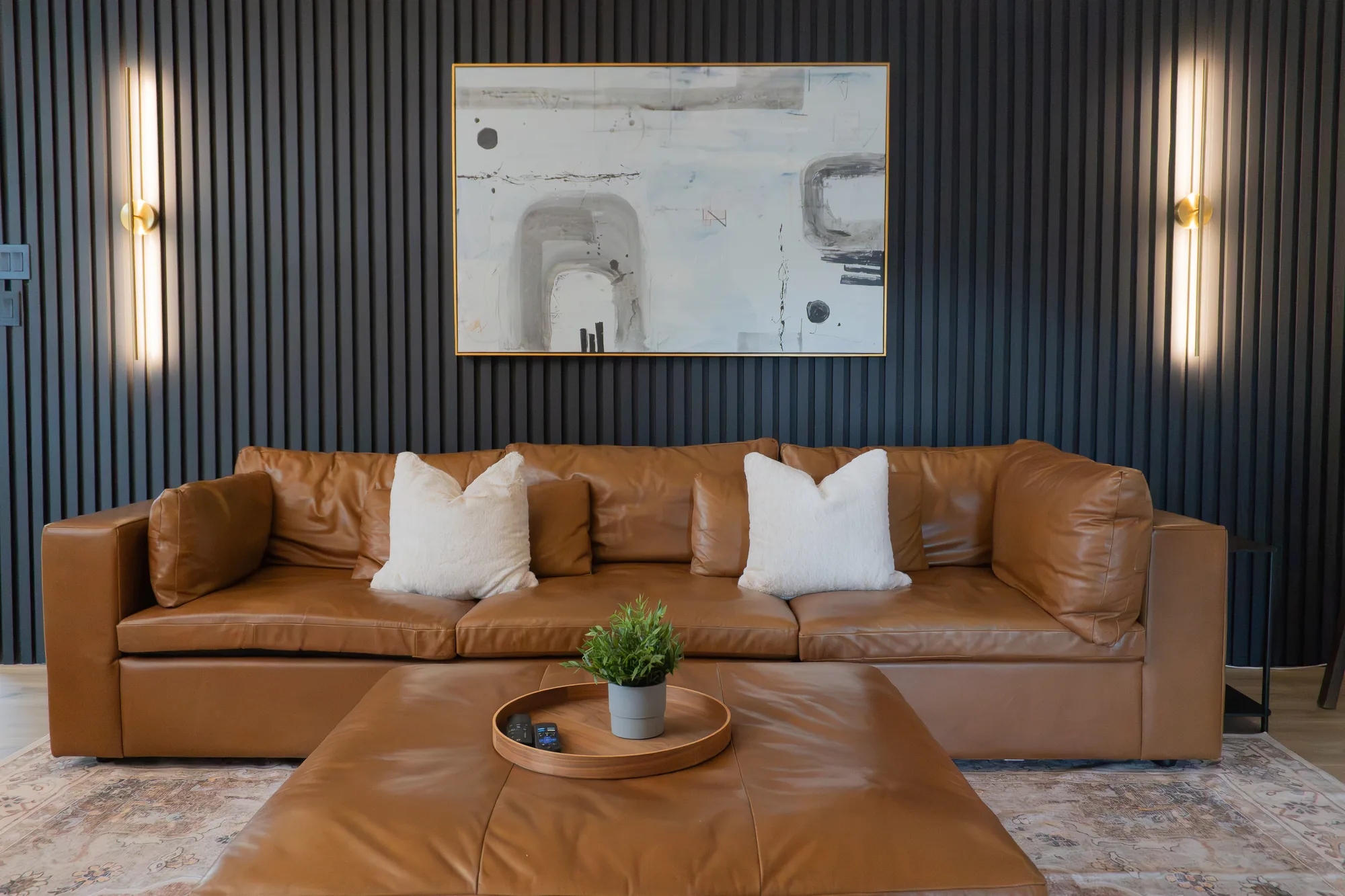 Leather sectional and abstract art wall