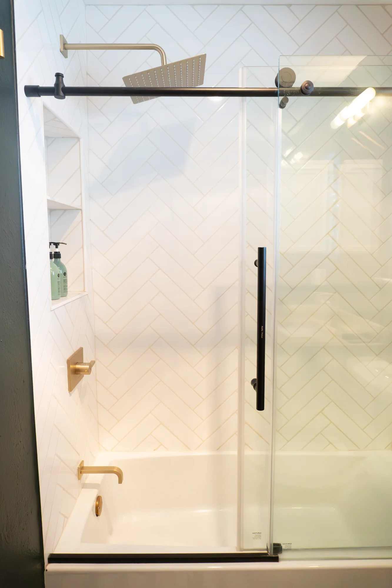 Herringbone tile shower and soaking tub
